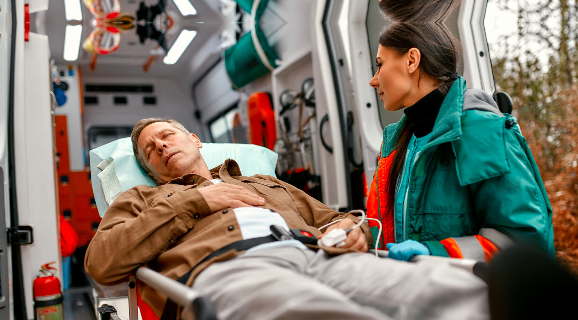 A woman push a stretcher with a man on it